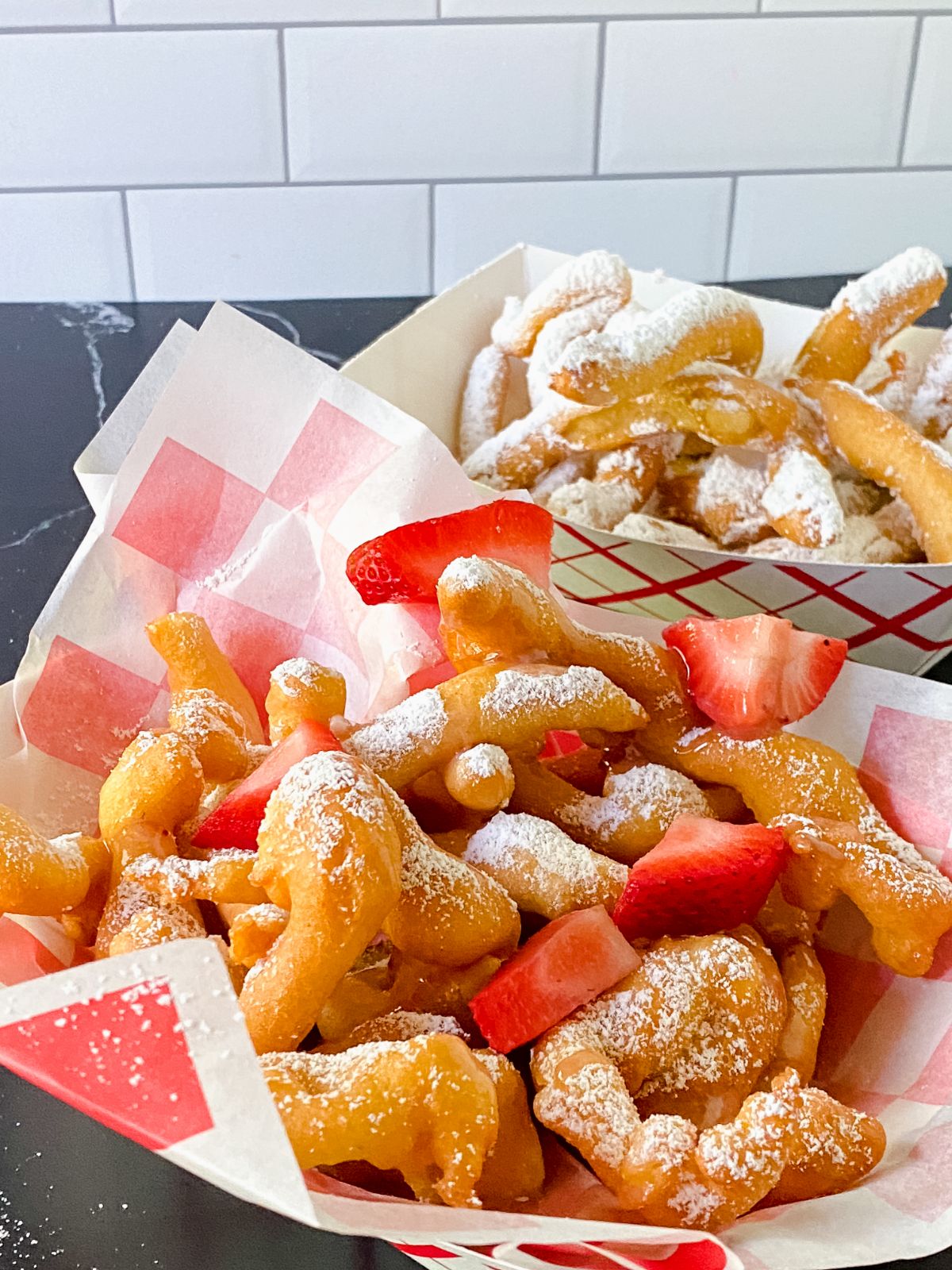 white and red paper under funnel cake fries