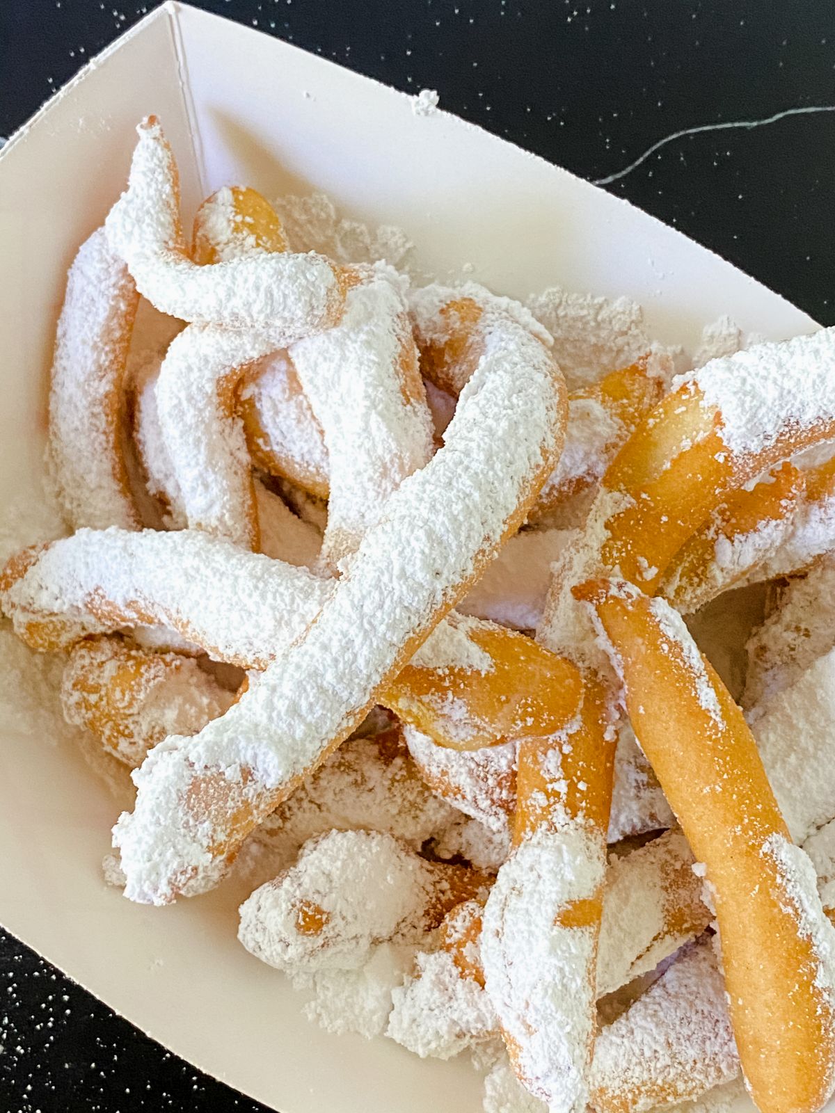 white plate of funnel cake fries