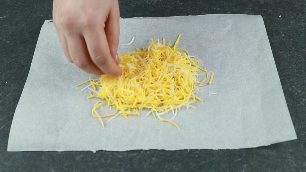 hand putting cheese on parchment paper