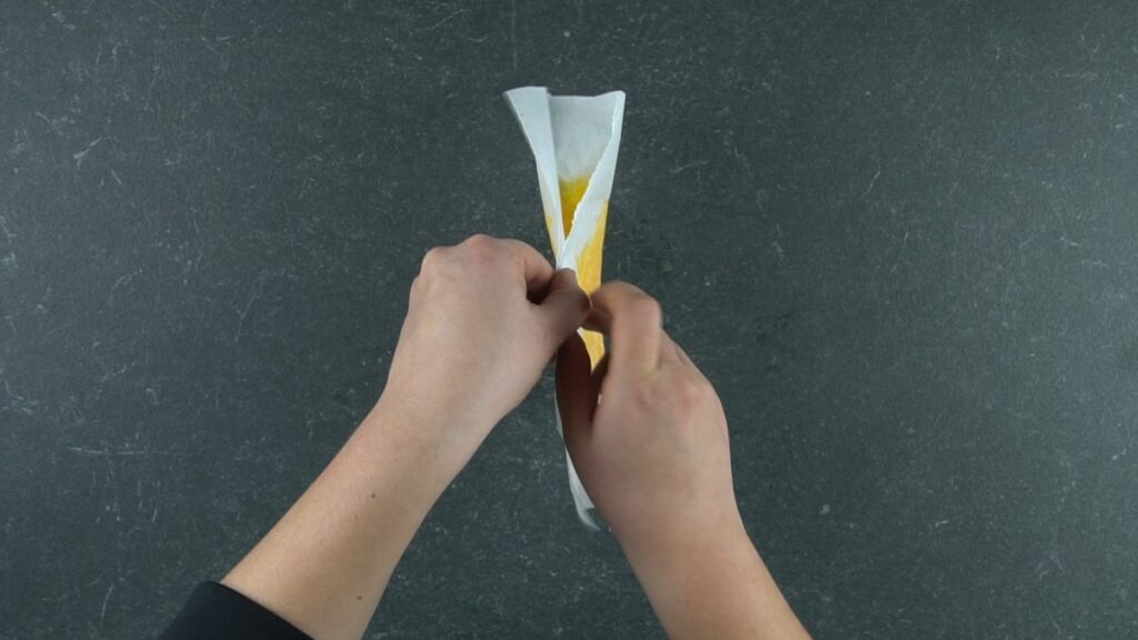 folding melted cheese on parchment