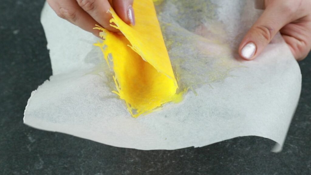 cheese being pulled from parchment paper