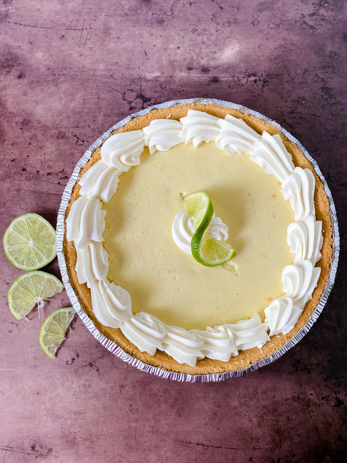 whipped cream on edges of key lime pie