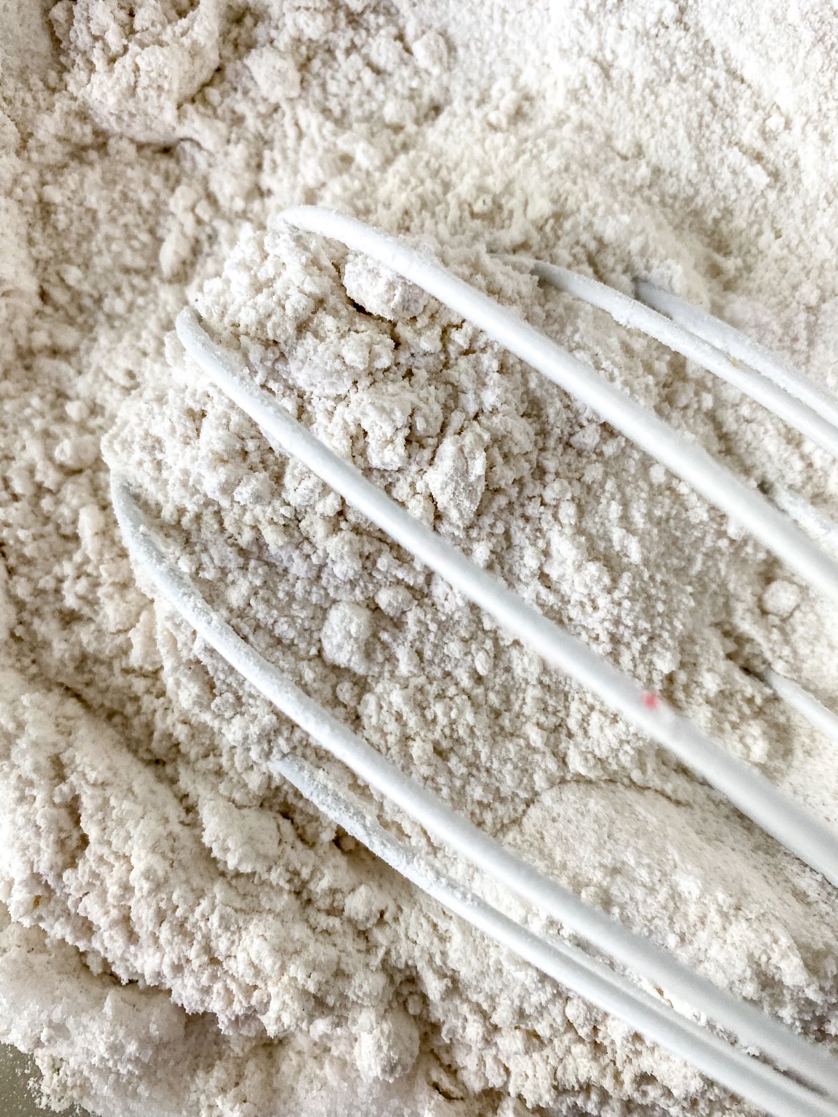 flour being whisked with white whisk