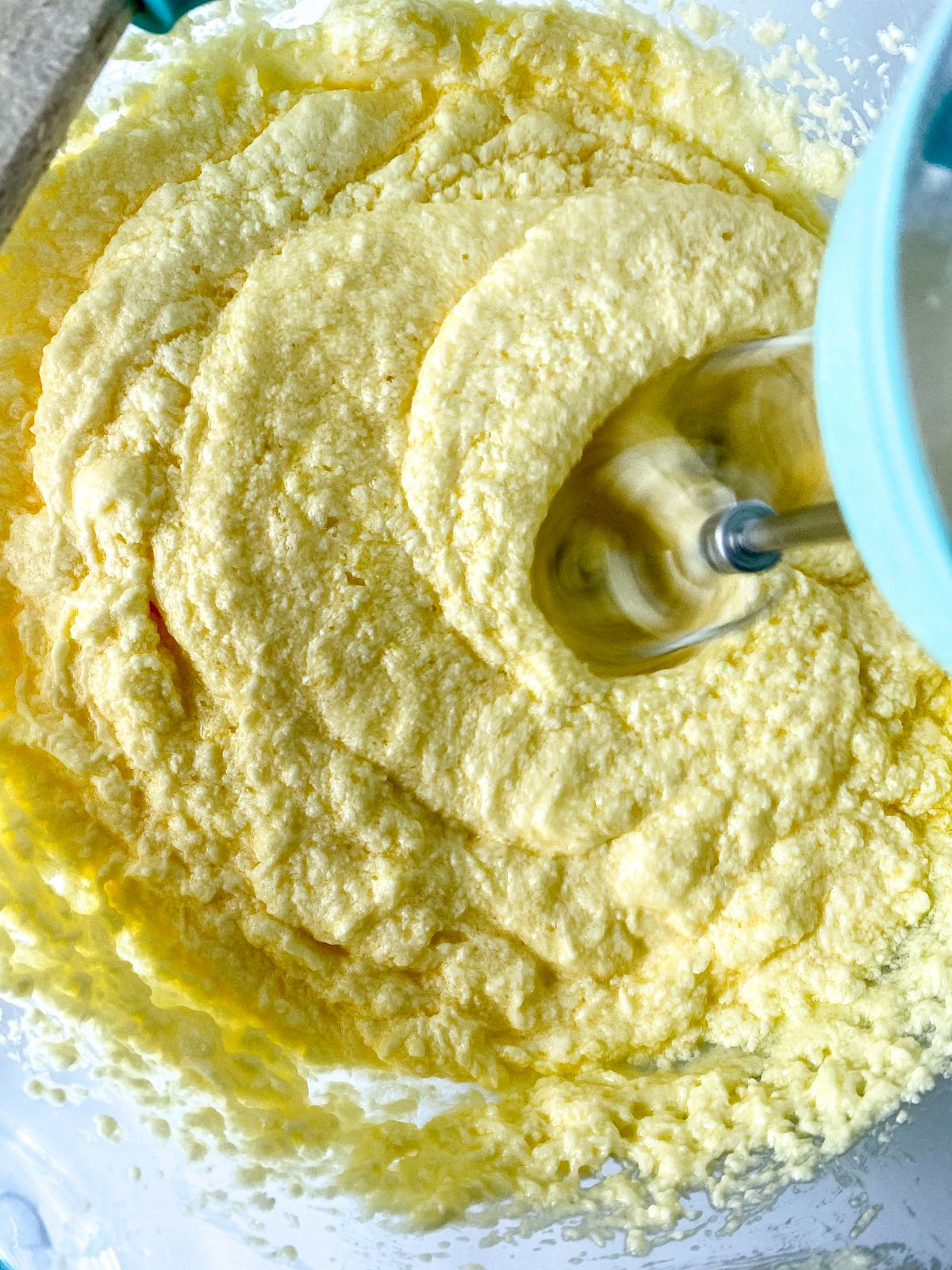 creamed butter in bowl with hand mixer