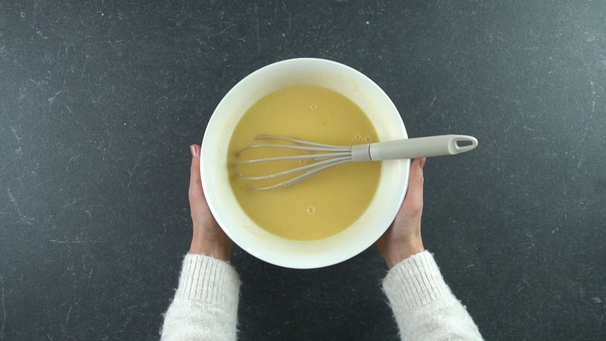 olive oil and eggs whisked in lareg white bowl