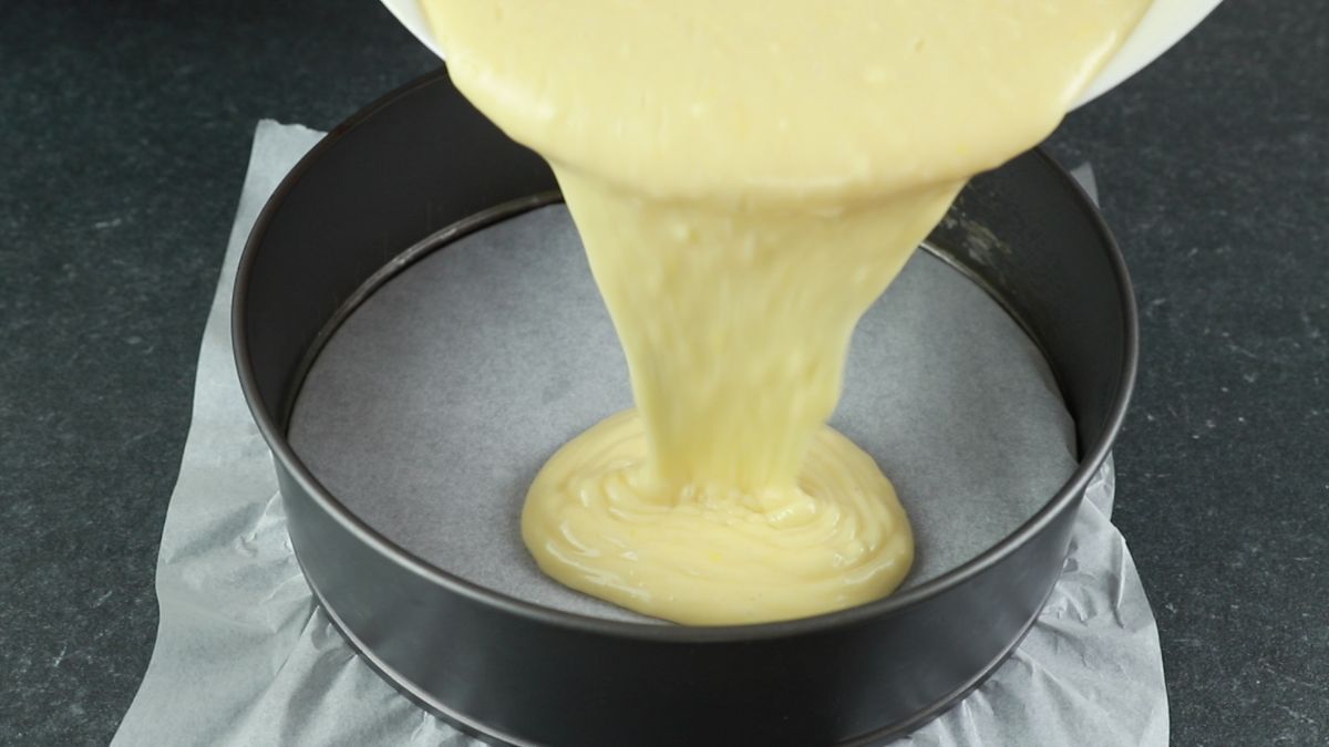 pouring batter into round cake pan