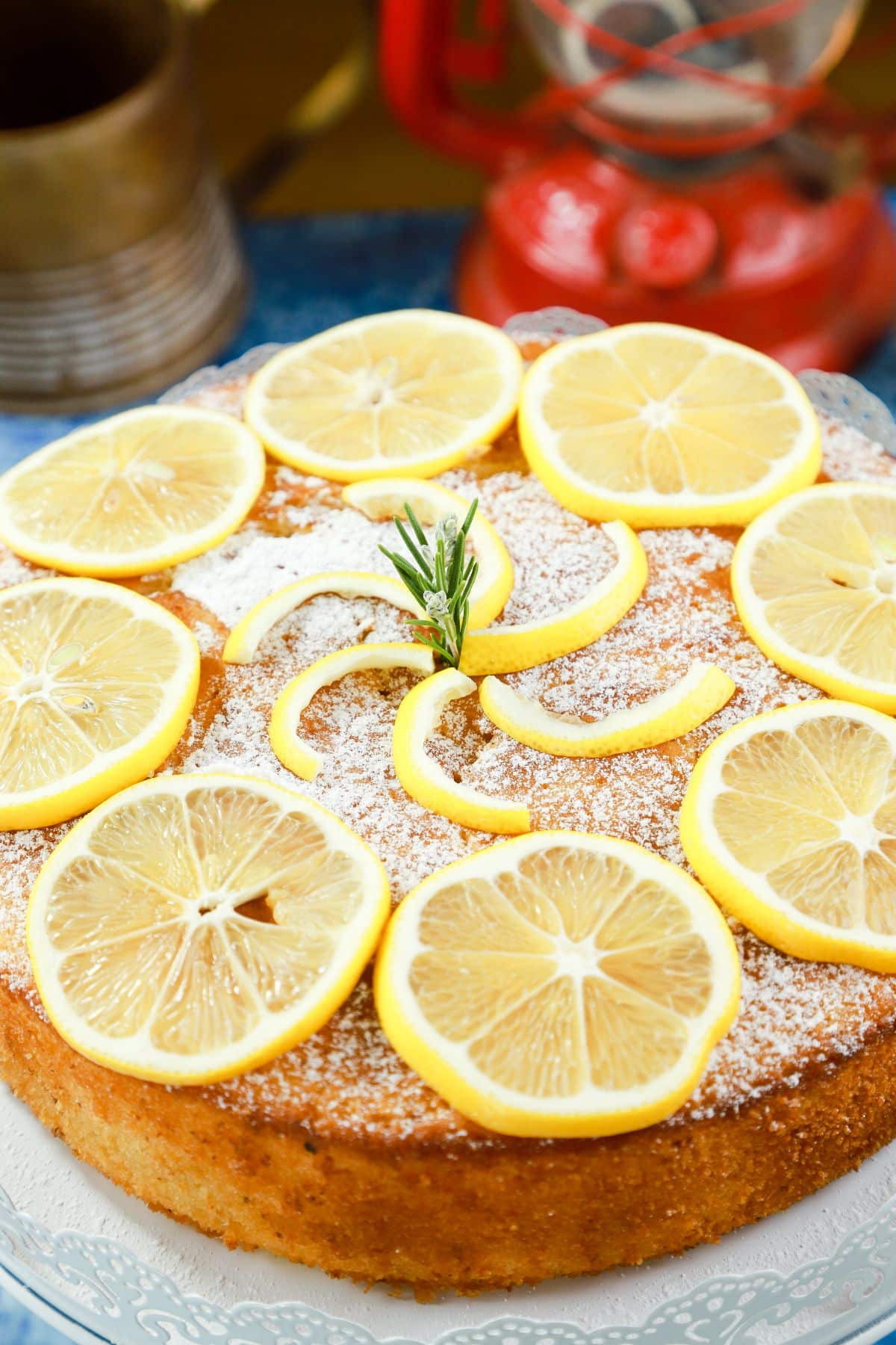 round lemon olive oil cake topped with sliced lemons