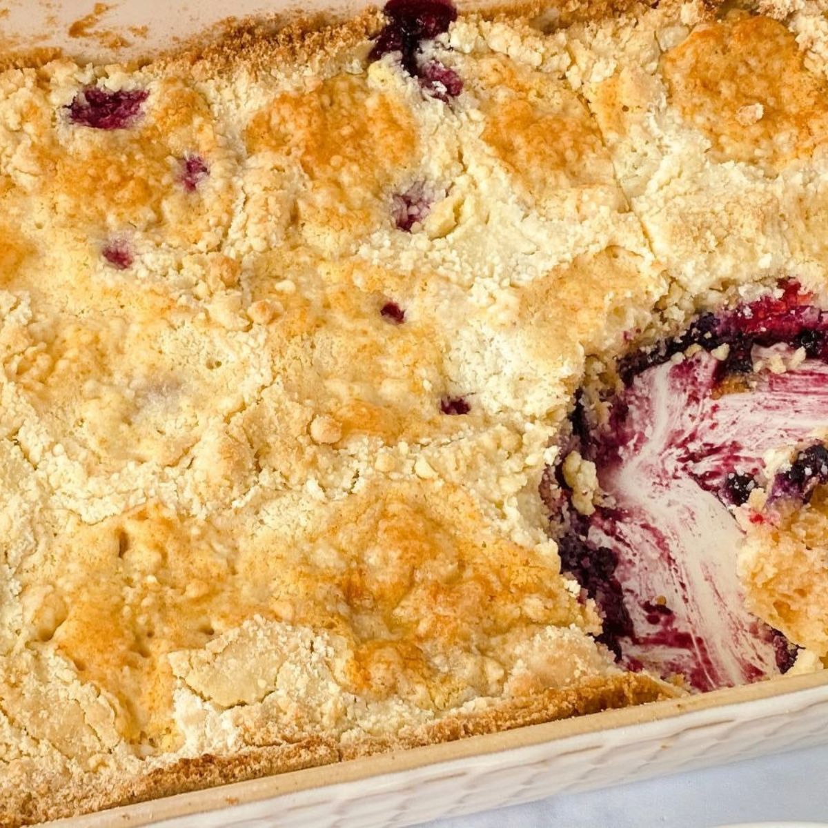 baking dish of mixed berry dump cake with spoon removed