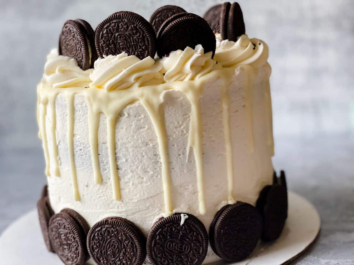 layered cake with white frosting and whole oreo cookie decorations