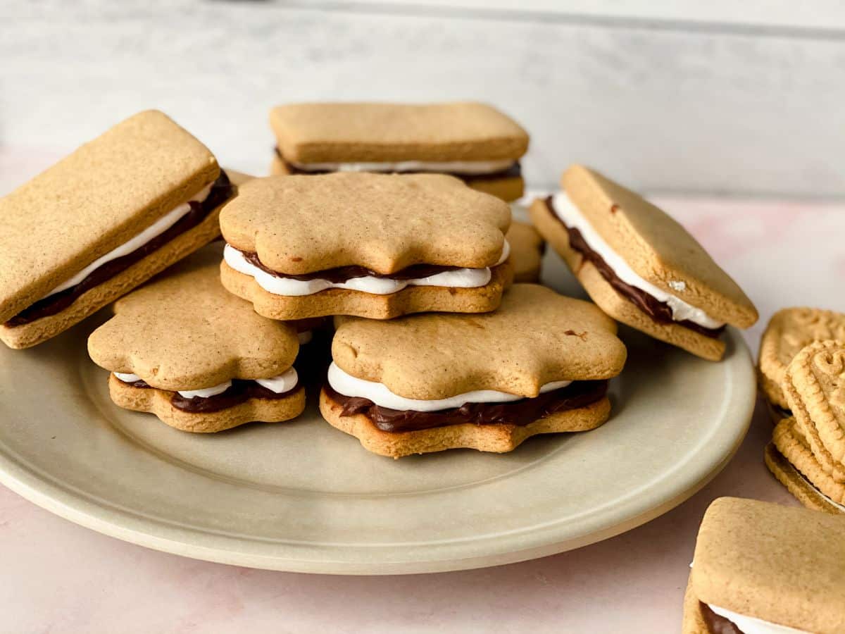 stacked cookies with chocolate and marshmallow in the middle on plate