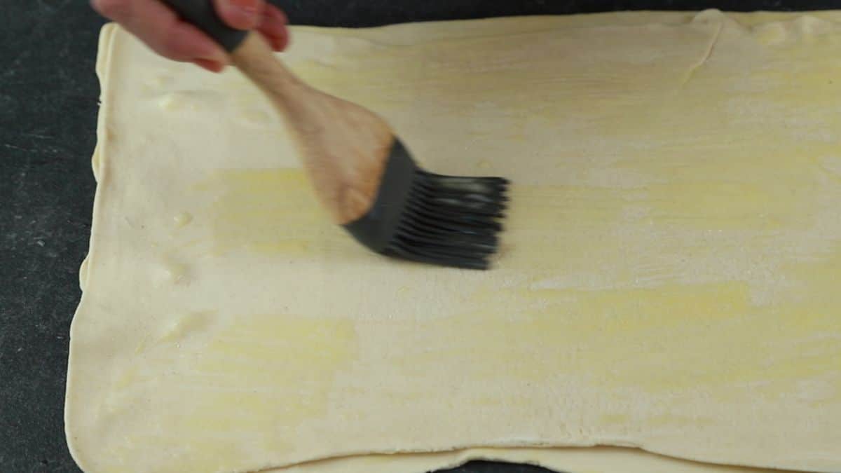 pastry brush adding butter to puff pastry
