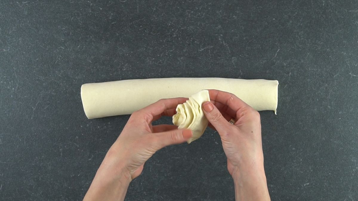 hand forming cone out of pastry