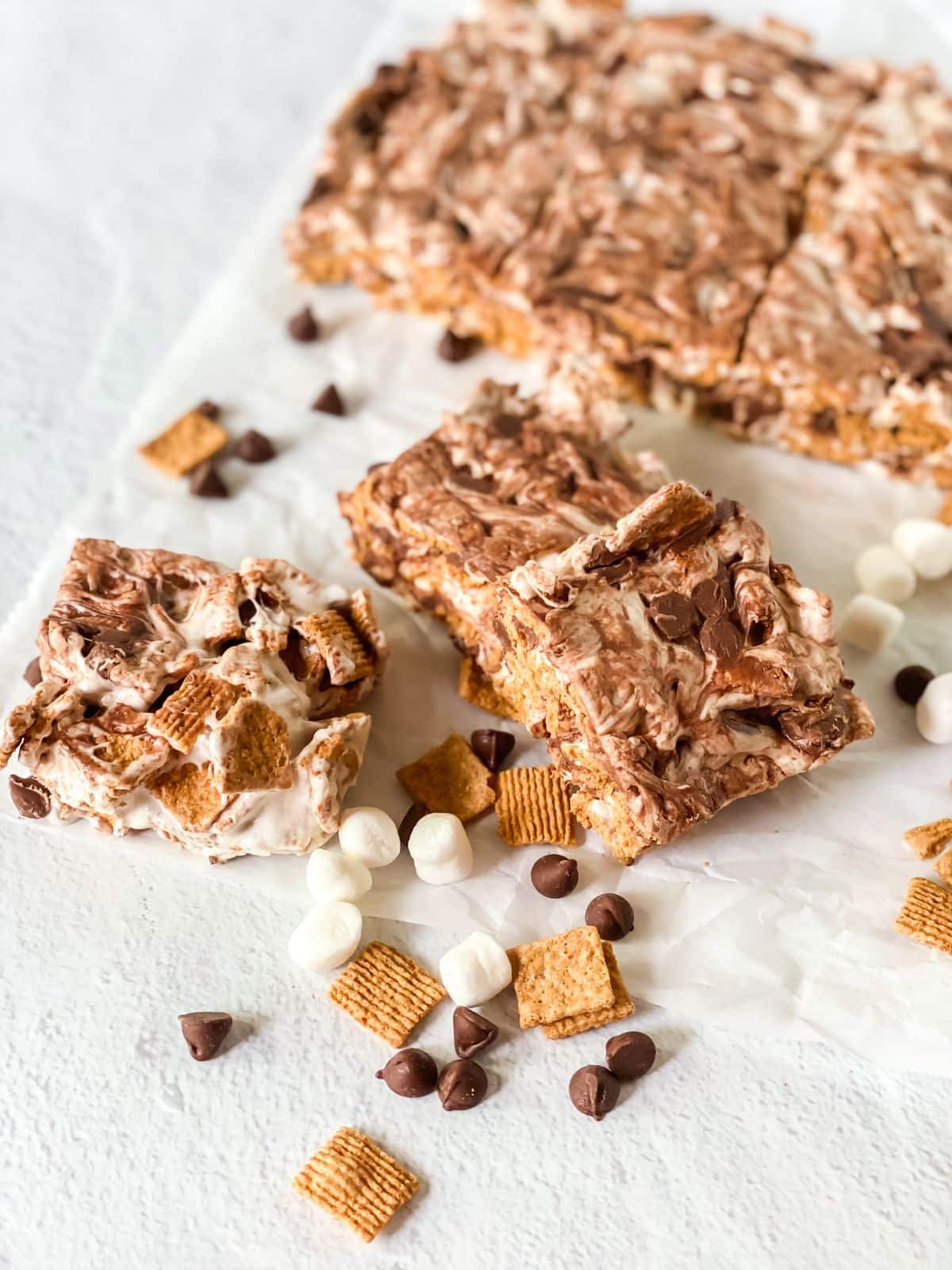 squares of s'mores cereal bars on white table