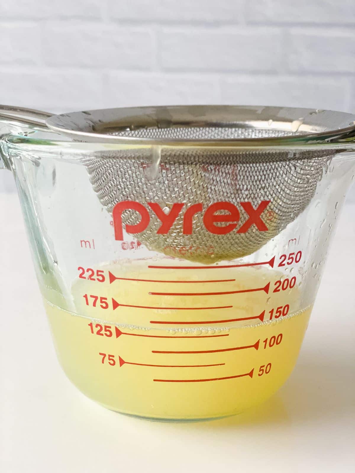 glass measuring cup of lemon juice