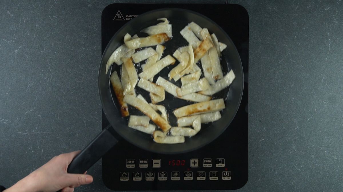 crispy tortilla strips in skillet