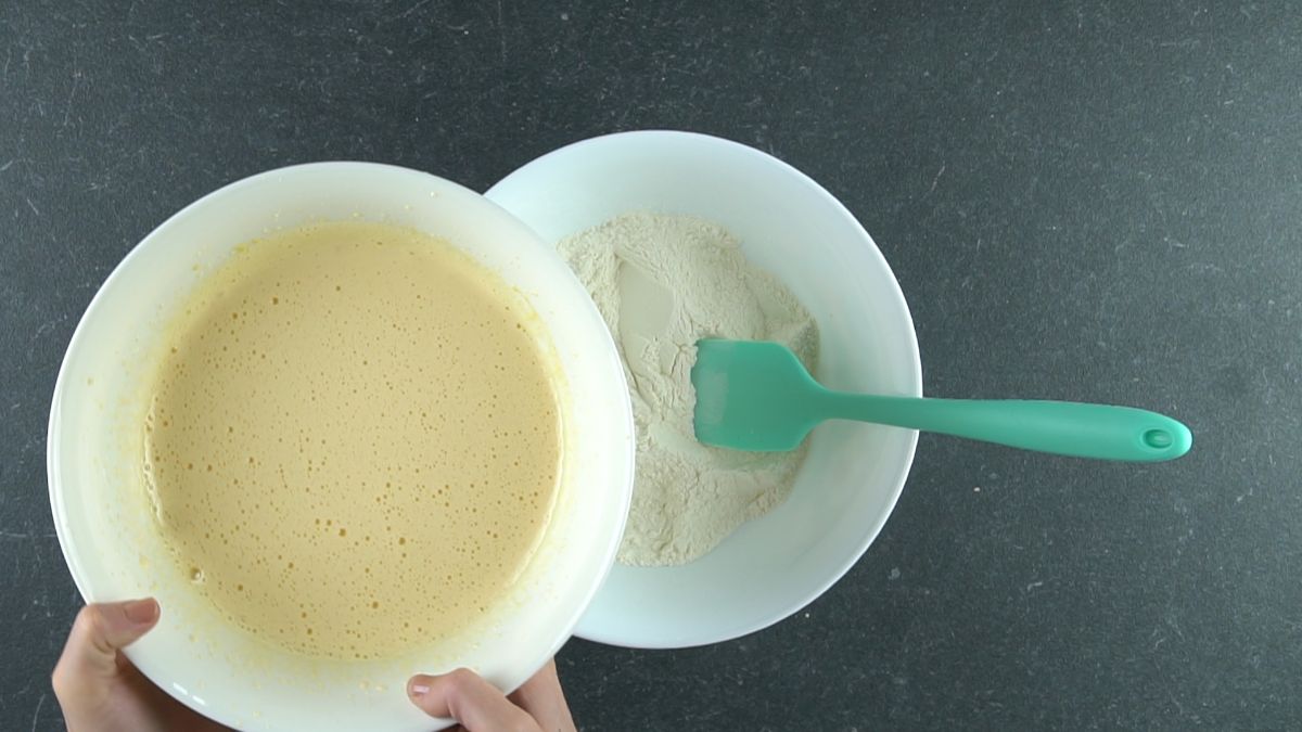 wet ingredients in bowl above bowl of flour