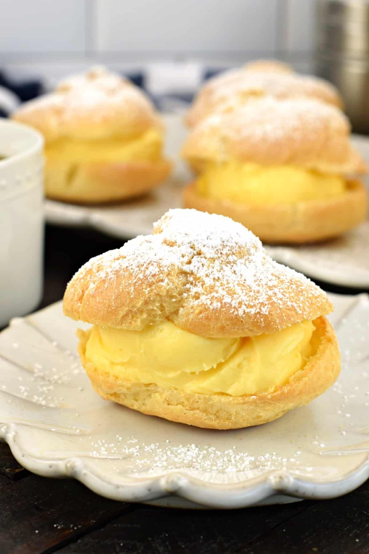 Cream Puffs on small shell-like plates.