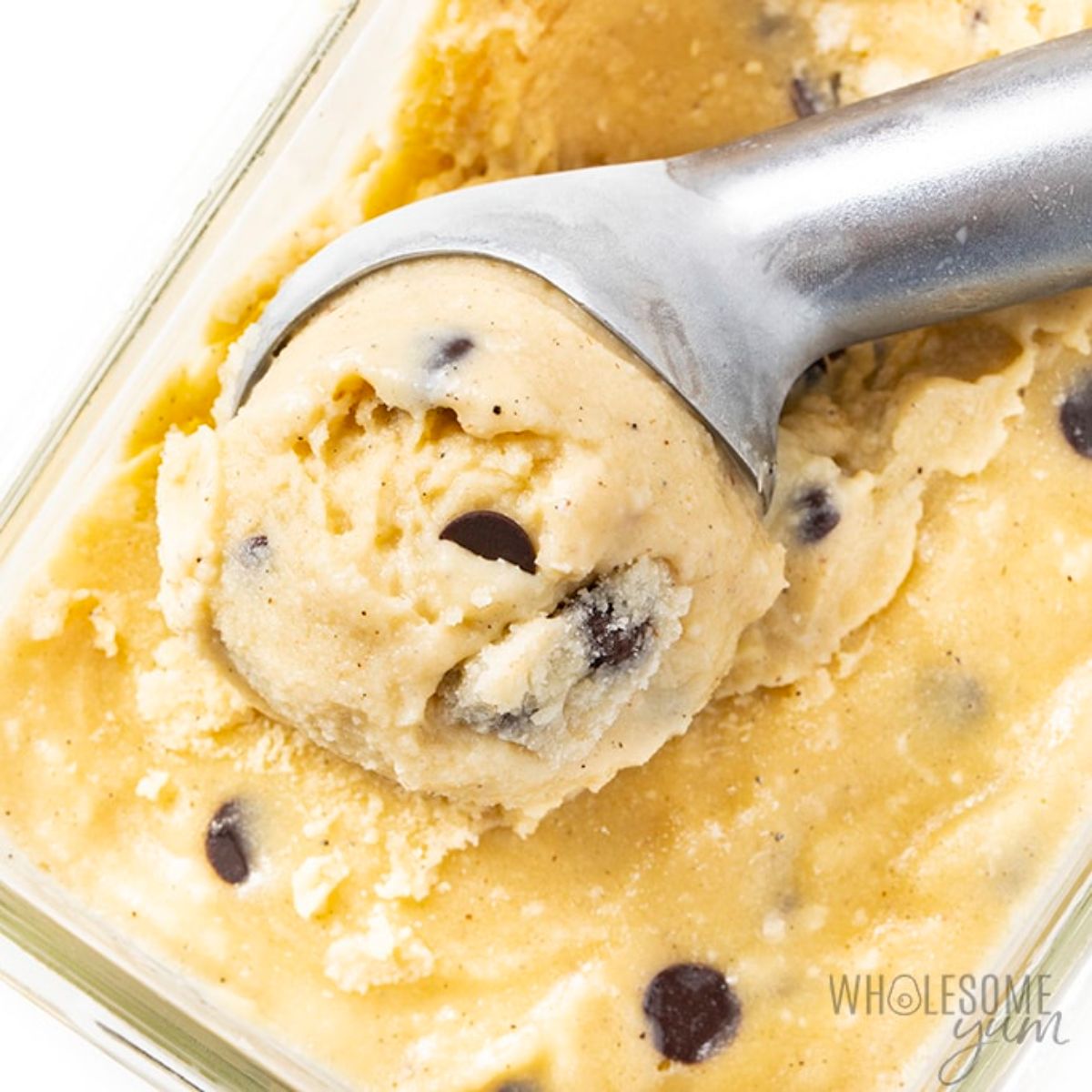 Sugar-Free Almond Milk Ice Cream in a glass container with a spoon.