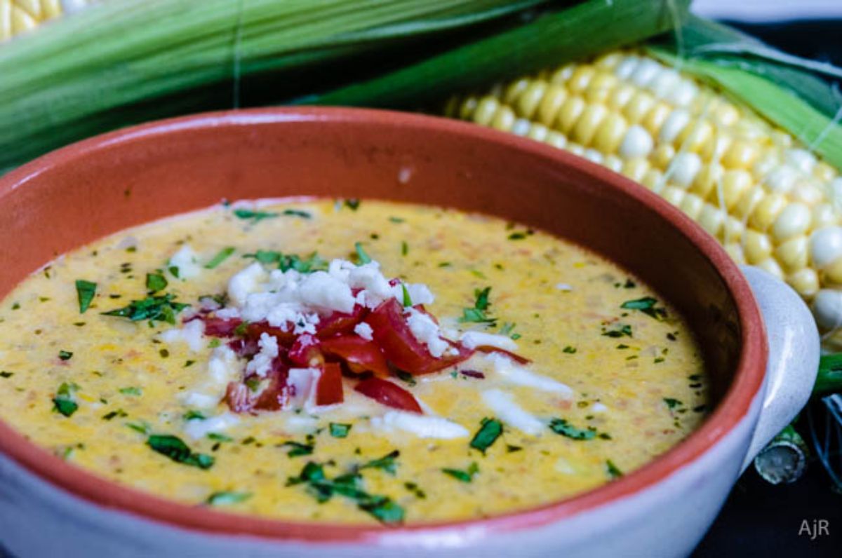 Sopa de Maiz mexican corn soup in a blue bowl with red edges.