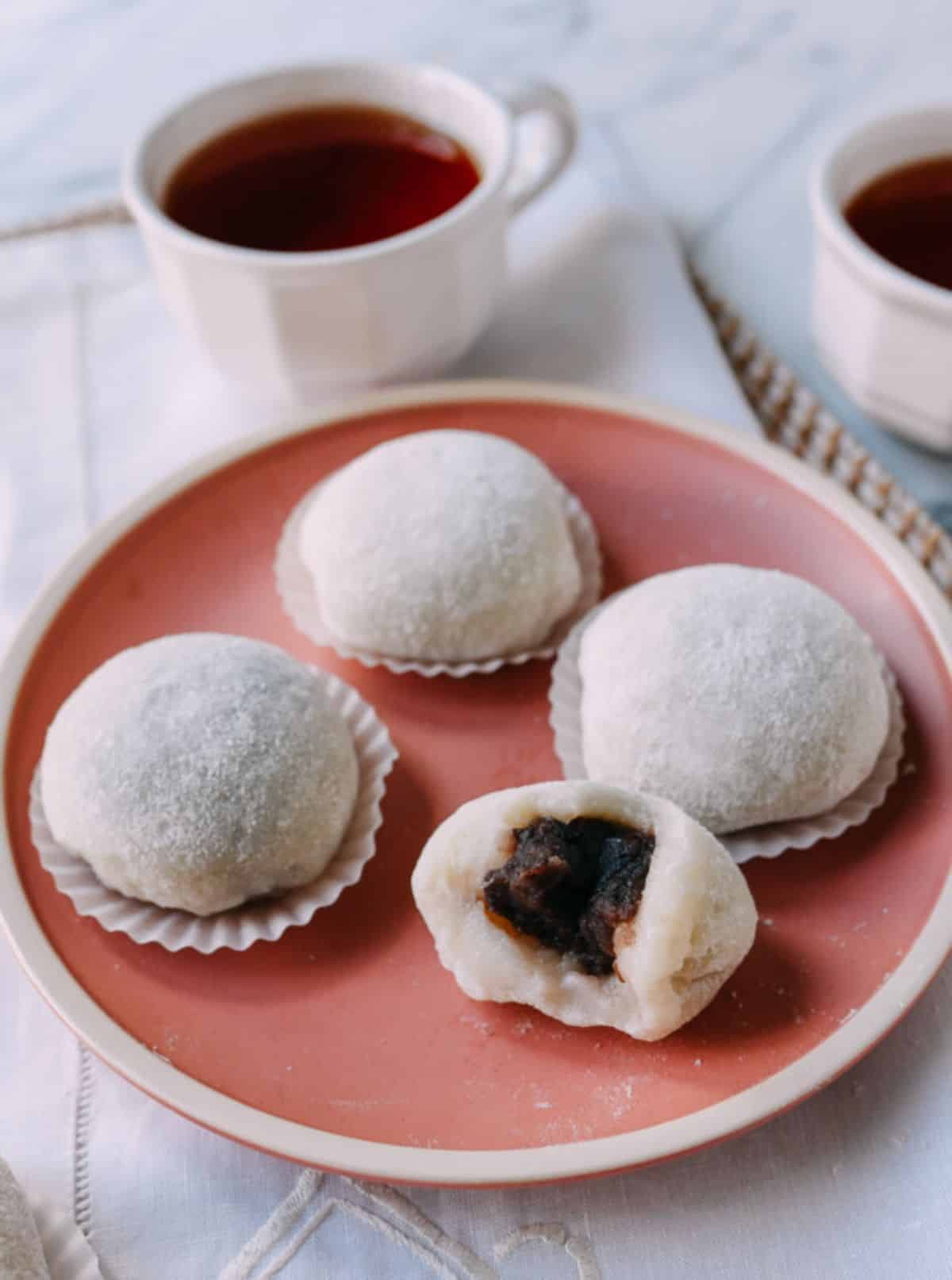 Red Bean Mochi desserts on a red plate.