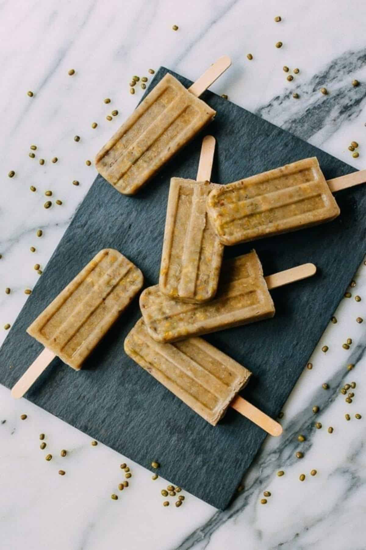 Mung Bean Popsicles on a black board.