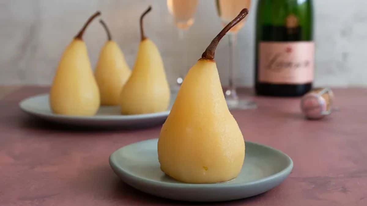 Champagne Poached Pears on small gray plates.