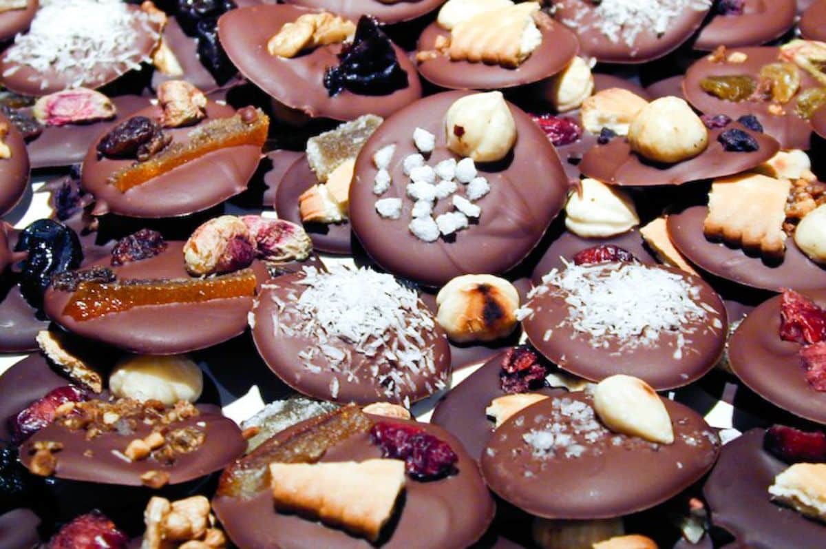 French Chocolate Mendiants covered with hazelnuts, peices of figs and almonds.