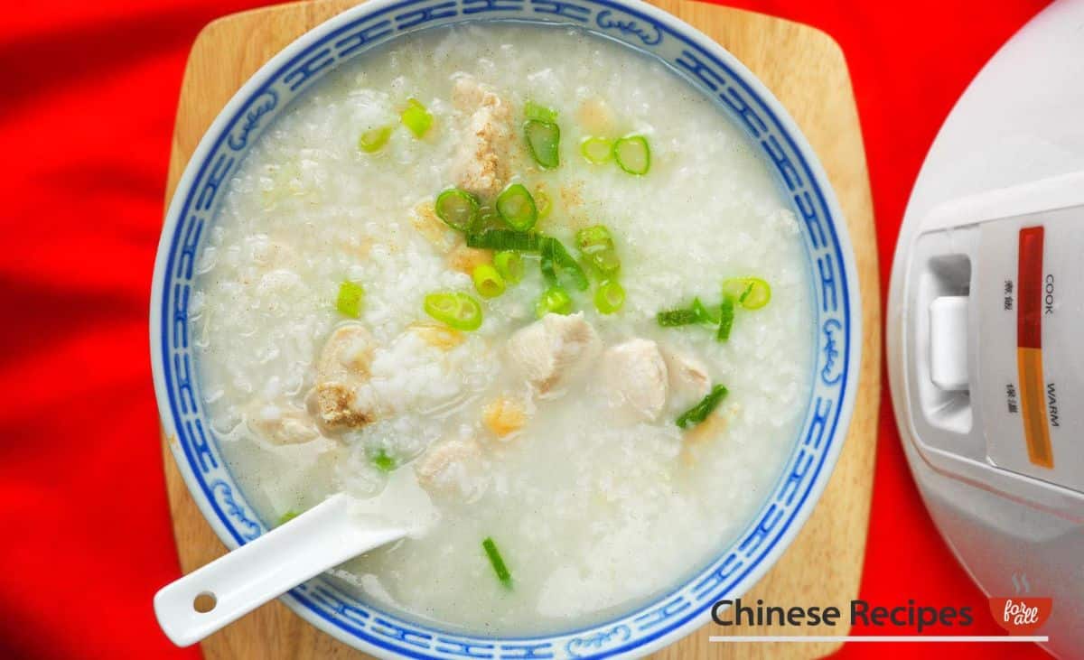 Chicken Congee Rice on a plate with a plastic spoon.