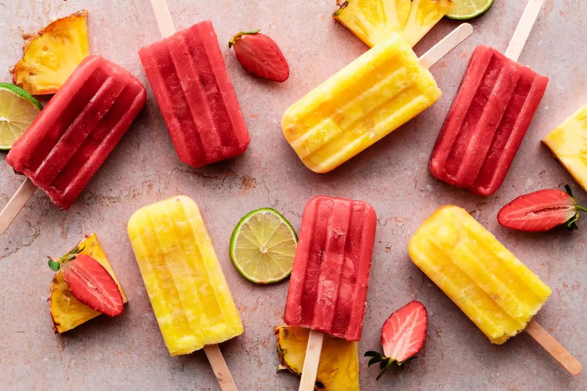 Paletas mexican frozen treats with sliced fruits.