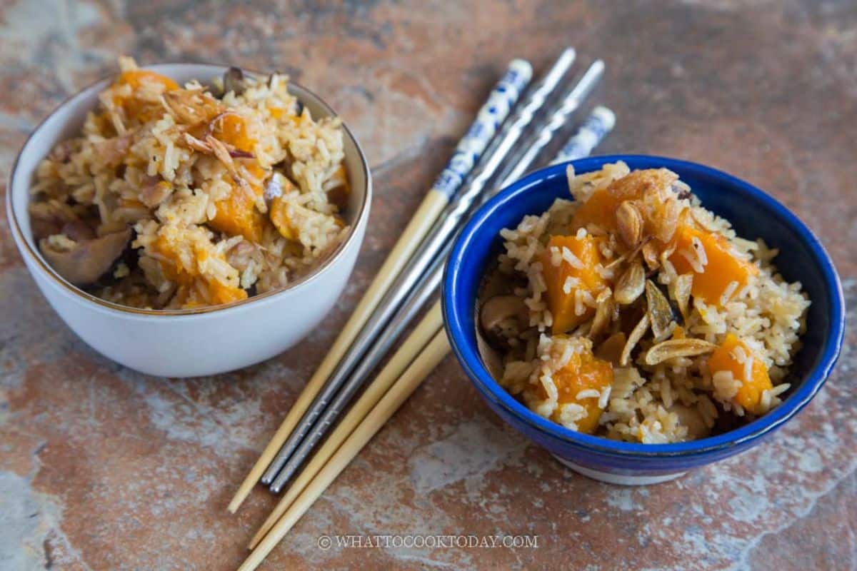 Chinese Pumpkin Rice in two bowls next to chopsticks.