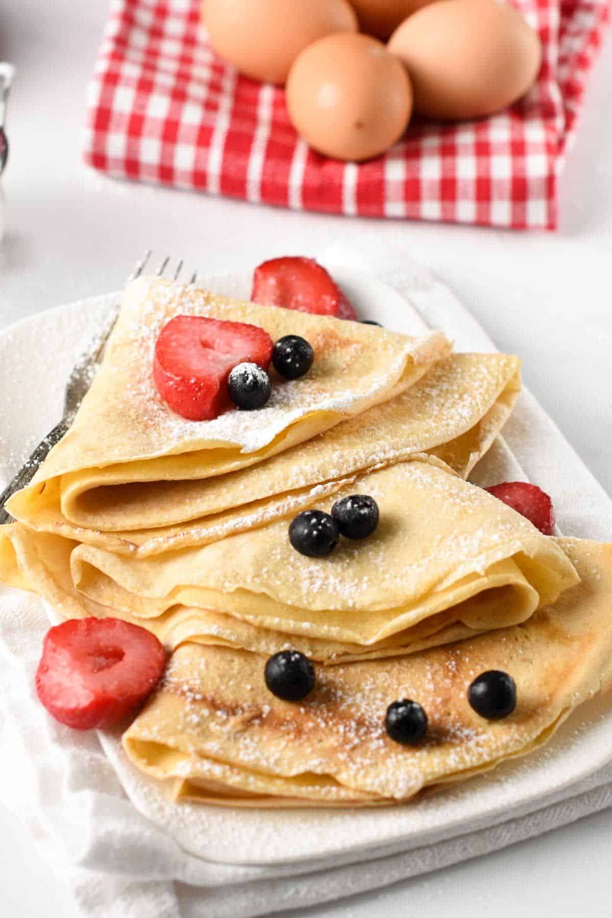 Authentic French Crepes with blueberires and strawberries on the top.