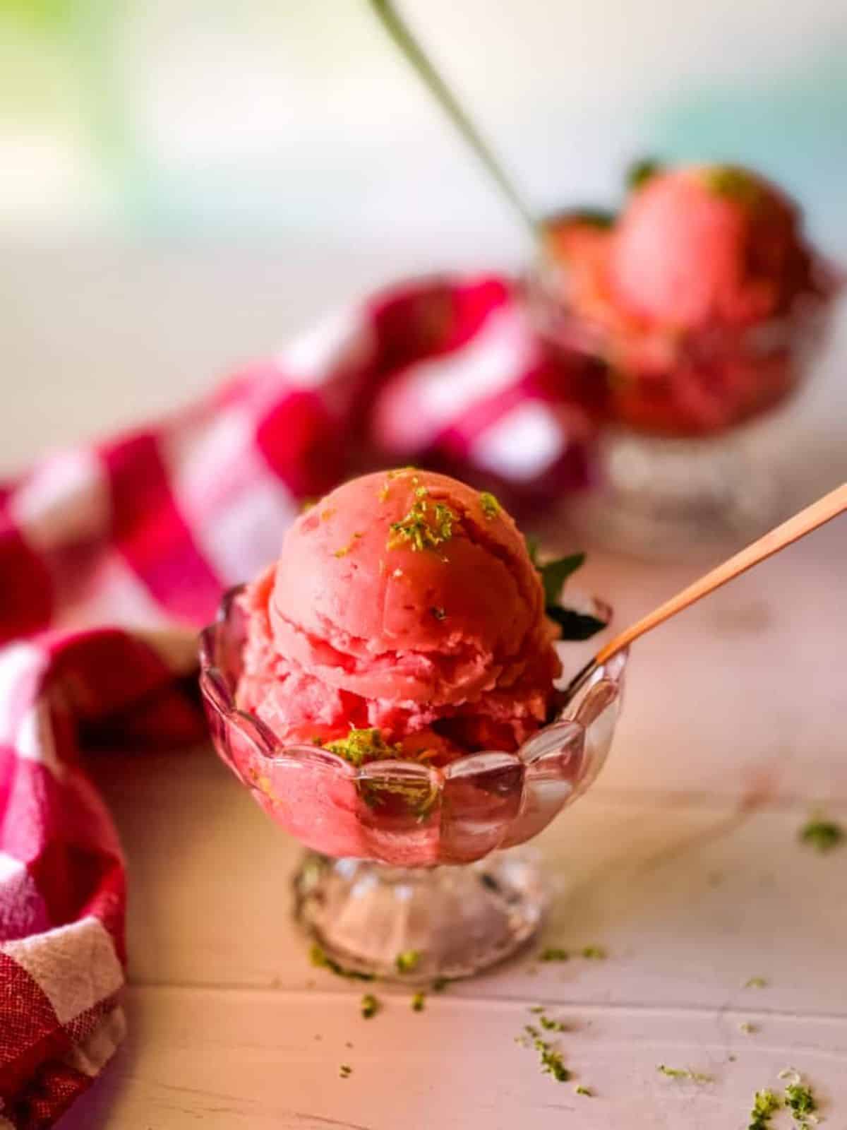 Vegan Watermelon Ice Cream in a glass cup with a spoon.