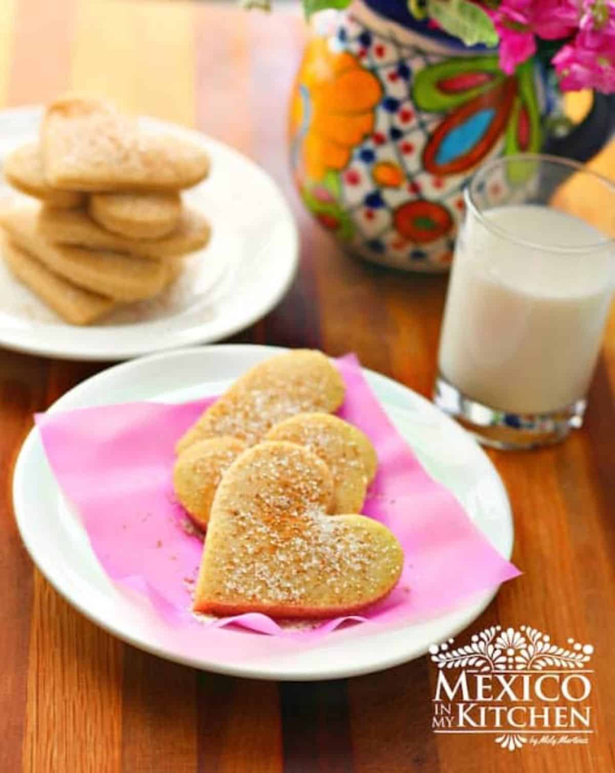Hojarascas mexican cookies on a pink napkin on a white plate.