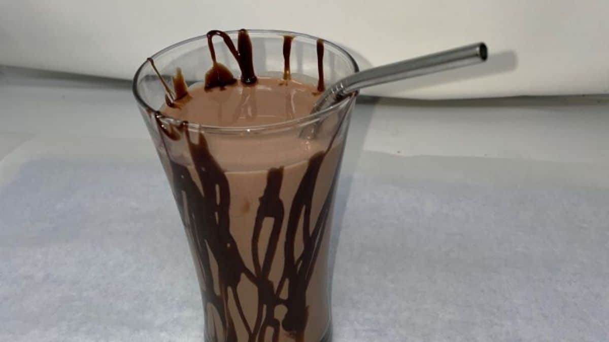 Chocolate Proyo Milkshake in a glass cup with a spoon.
