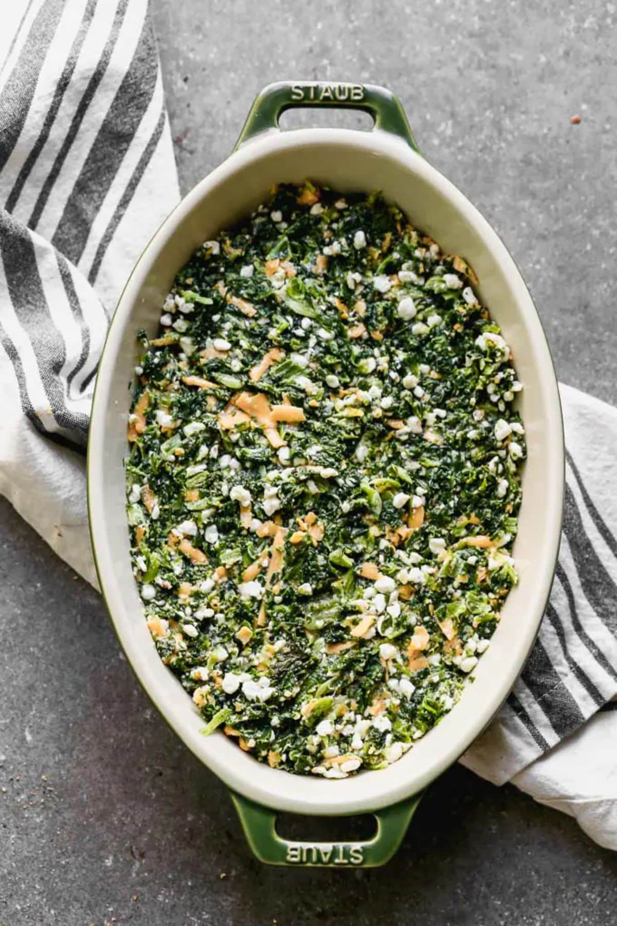 Baked Spinach in a white casserole.