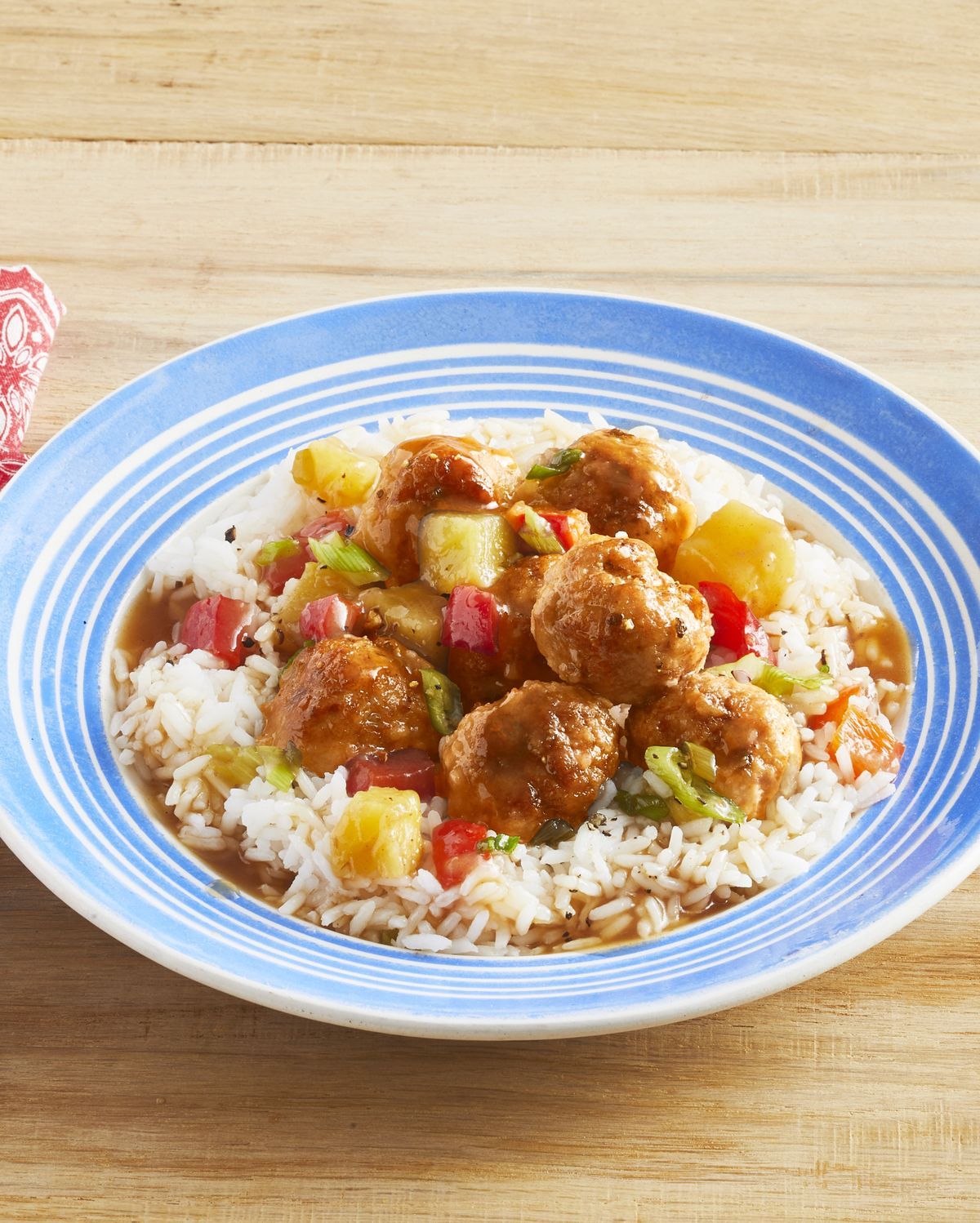 Sweet-and-Sour Pork Meatballs With Pineapple on a blue-white palte.
