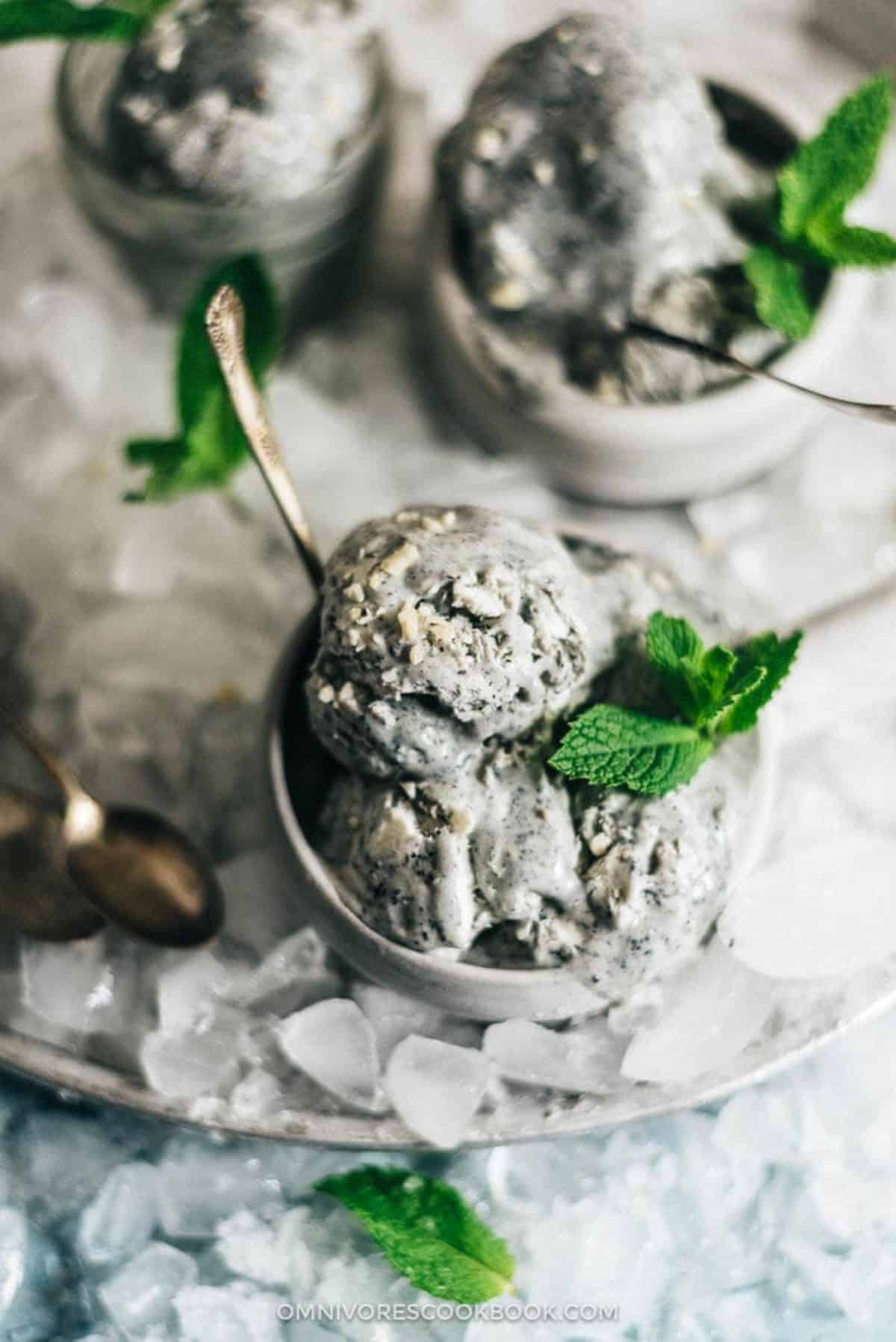 Black Sesame Ice Cream in small bowls with a spoon.