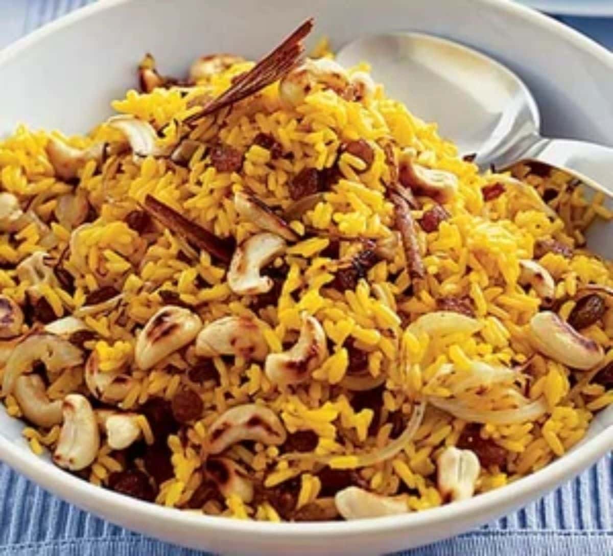 Spicy Indian Rice in a white bowl with a spoon.