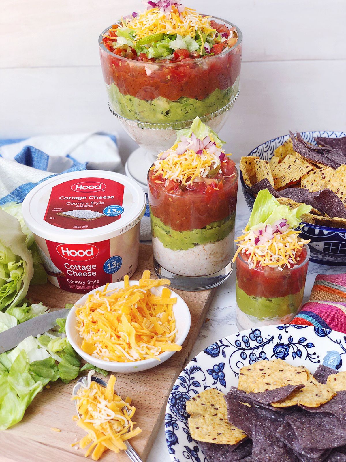 Mexican Cottage Cheese Dip in glass cups with ingredients on a table.