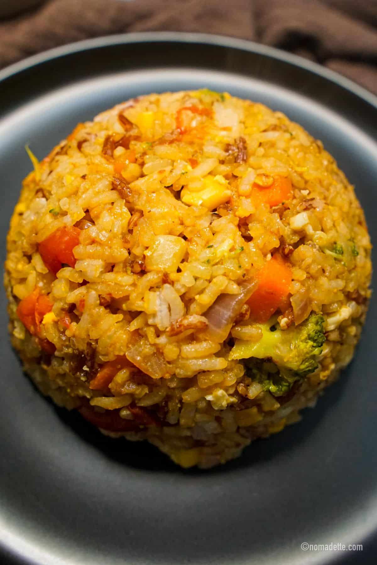 Rainbow Fried Rice ball on a gray plate.