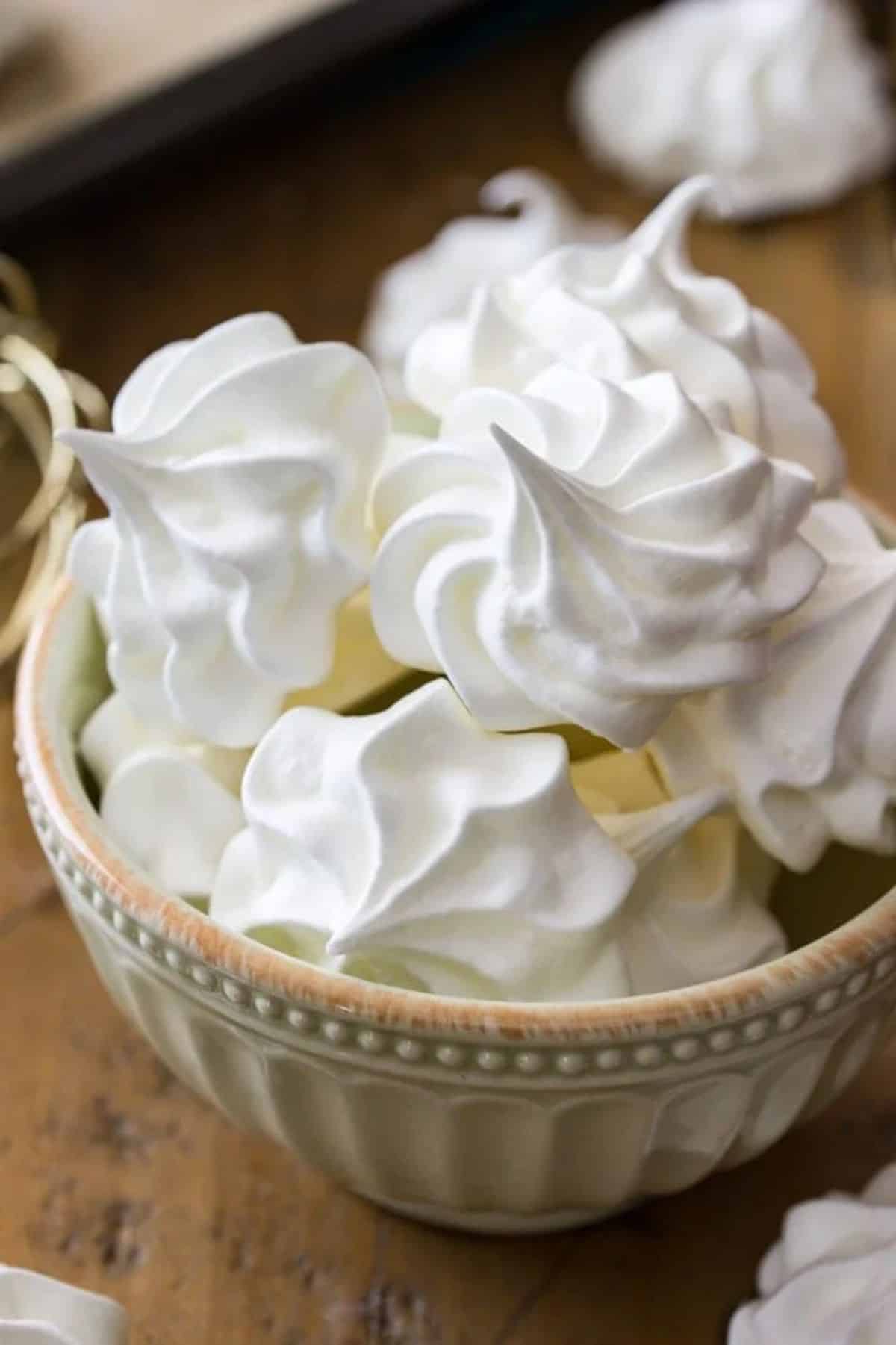 Meringue cookies in a small gray bowl.