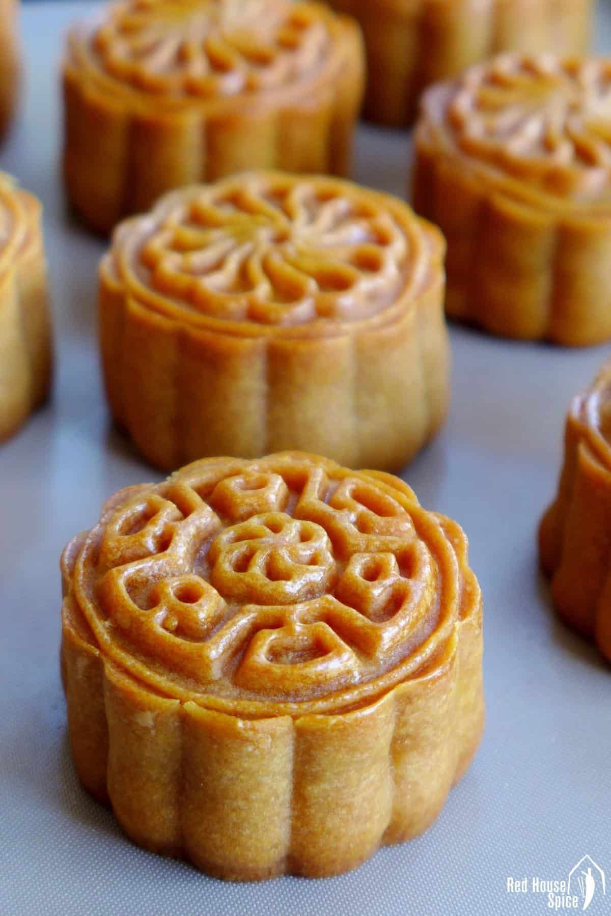 A bunch of Mooncakes on a gray tray.