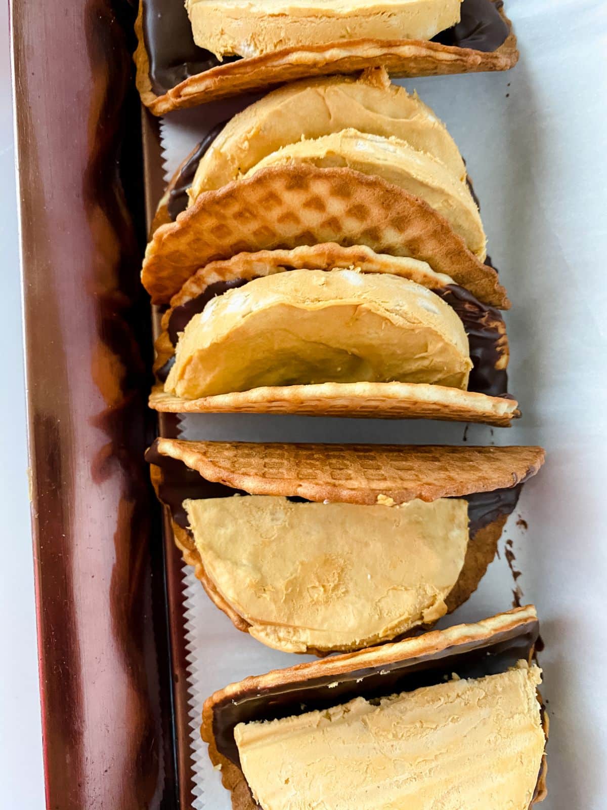 waffle cones with banana ice cream discs laying on brown platter