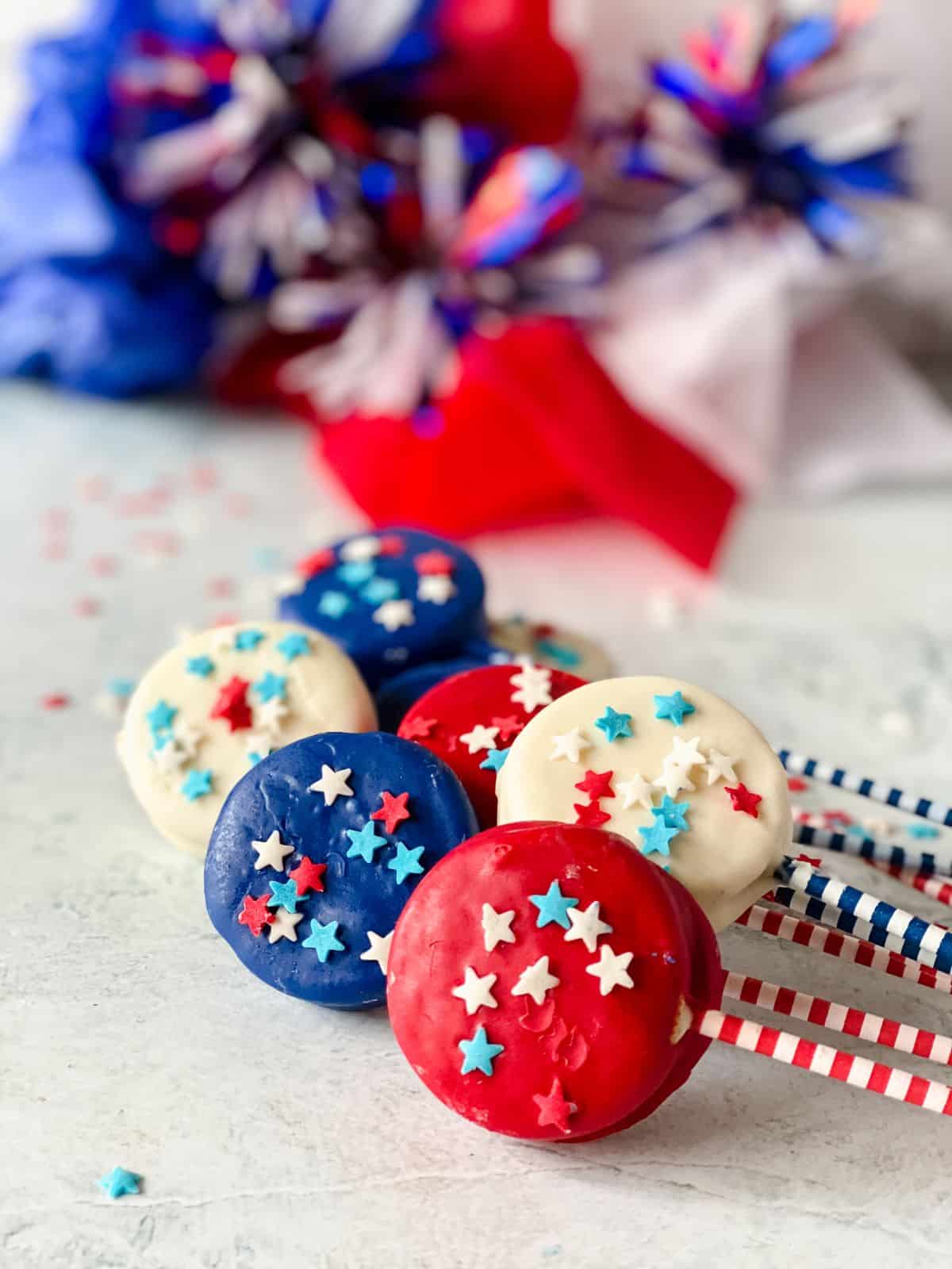 holiday bunting on table behind patriotic dipped cookies